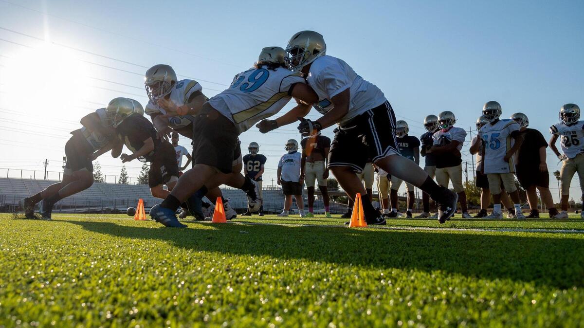 Burbank High School football players practice with coach Eddie Elder at the Burbank High School on Monday, August 16, 2021 in Sacramento.