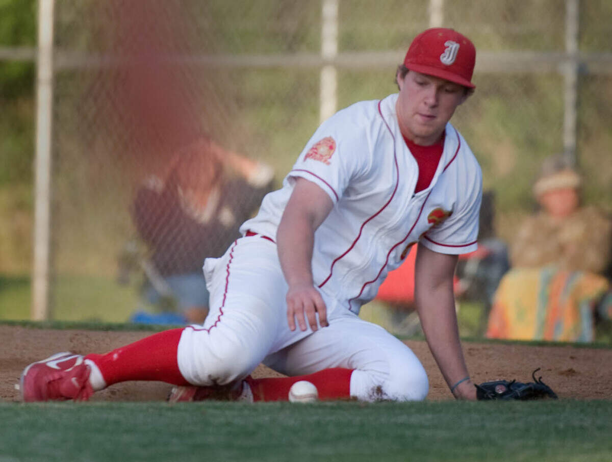 Jesuit’s Rhys Hoskins slides to pick up a ball and relay it to the pitcher for the out during the Division I section championship game at American River College on Tuesday, June 1, 2010.