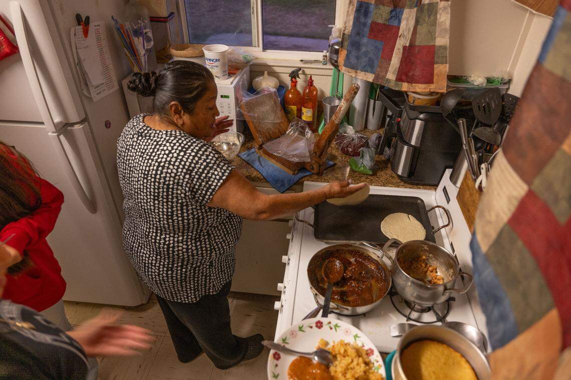Maria Perez makes tortillas for her family in their apartment at the Lodi migrant center in October. Her family has been traveling from Mexico to work in the Lodi area for generations.