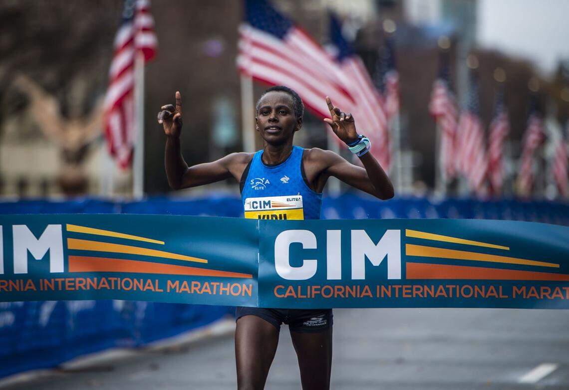 Jane Kibii crosses the finish line with a winning time of two hours and 29 minutes and 31 seconds at the California International Marathon in downtown Sacramento, Sunday, Dec. 8, 2019.