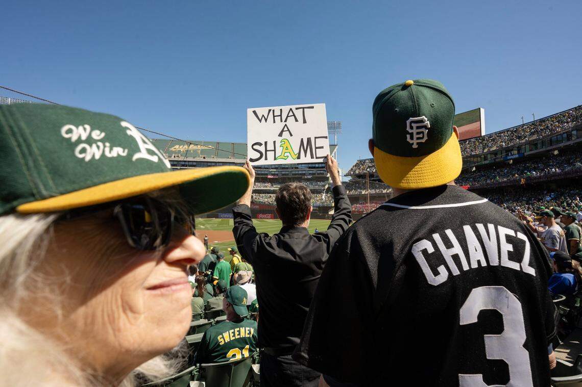 “What a shame,” reads a sign held by Jacob Russell-Snyder of Oakland before the A’s last game at Oakland-Alameda County Coliseum on Thursday.