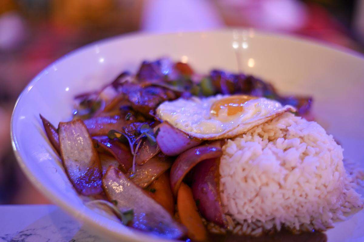 Lomo saltado a La Antigua, a stir-fried beef tenderloin dish with onions, tomatoes, soy sauce, fries, jasmine rice and a fried egg, served at Chicha Peruvian Bistro in Sacramento.
