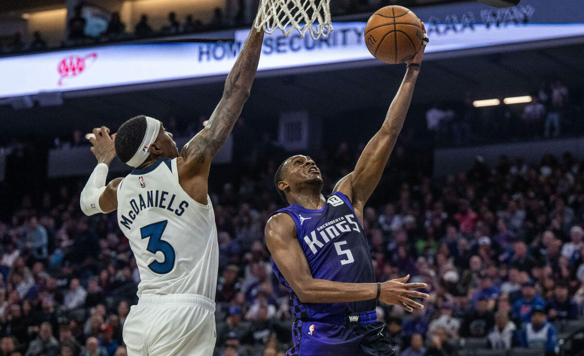 Sacramento Kings guard De’Aaron Fox (5) scores two of his franchise record 60 points against Minnesota Timberwolves forward Jaden McDaniels (3) on Nov. 15 at Golden 1 Center. 