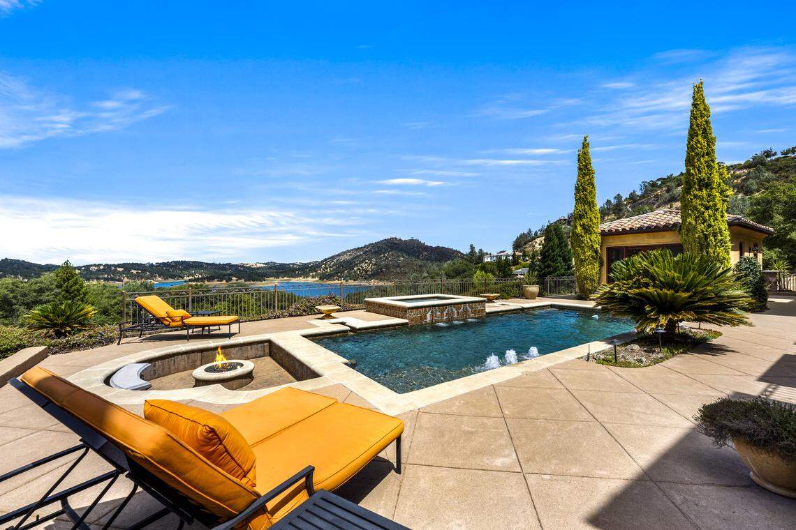 Resort-style backyard highlights include a sparkling pool with swim-up bar, relaxing spa, firepit lounge, and mature olive trees encircling the vineyard.