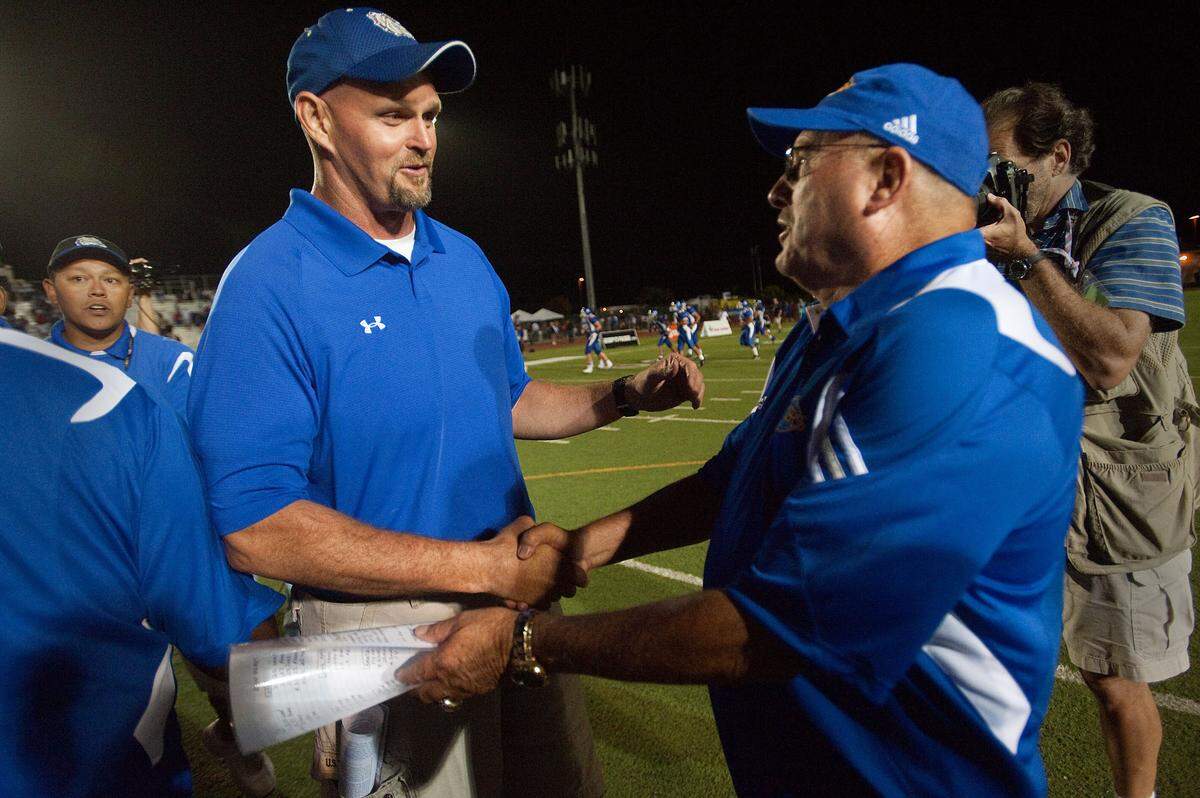 Folsom High School head coach Kris Richardson, left, congratulates Grant coach Mike Alberghini following a nationally televised game in Folsom on Friday, Aug. 27, 2010, that Grant won 49-14 in front of 20,000 fans. Neither team would lose until their rematch in the section final – which Grant entered ranked No. 1 in state. But Folsom turned the tables, winning its first section title in 20 years, 41-20, and became the region’s dominant power for the next decade.