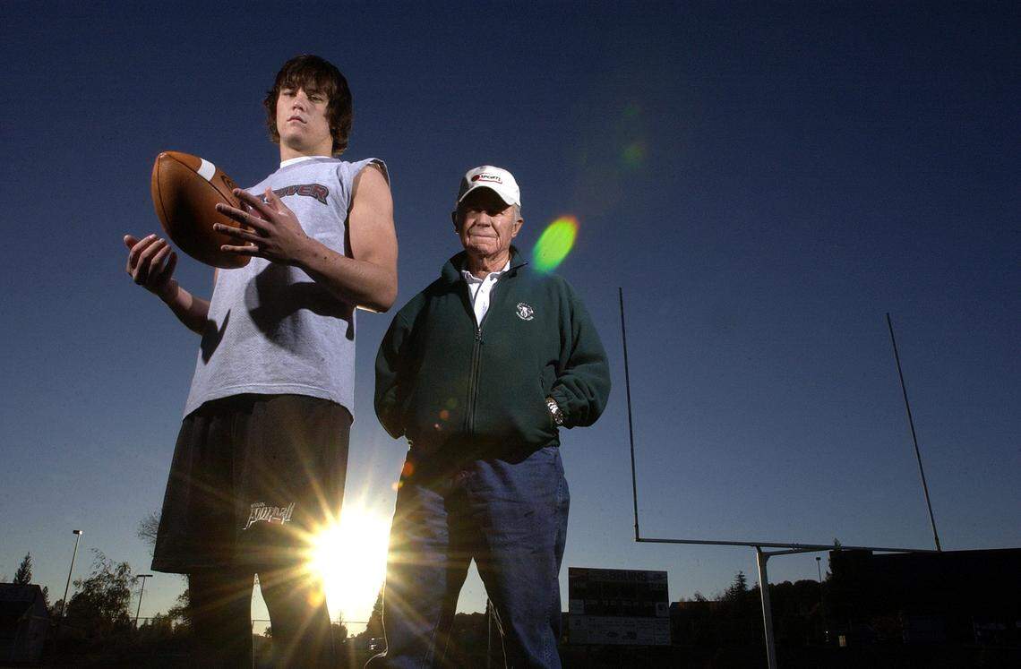 Bear River High School running back and linebacker Cody Yeager stands with his grandfather, aviation icon Chuch Yeager, as his team practices for the playoffs on Wednesday, Nov. 26, 2003.