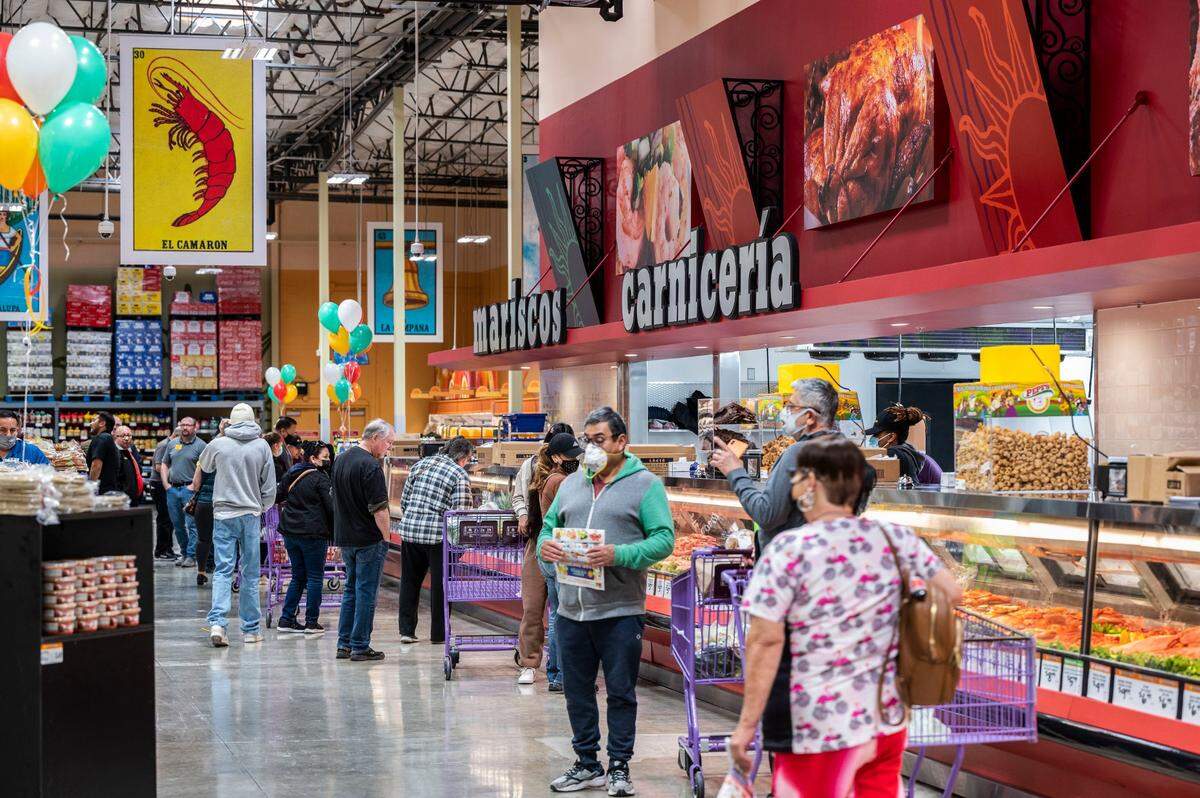 Customers shop during the grand opening of Rancho San Miguel Market in the Oak Park Neighborhood on Wednesday, March 2, 2022 in Sacramento. The store has a well stocked produce and meat market.