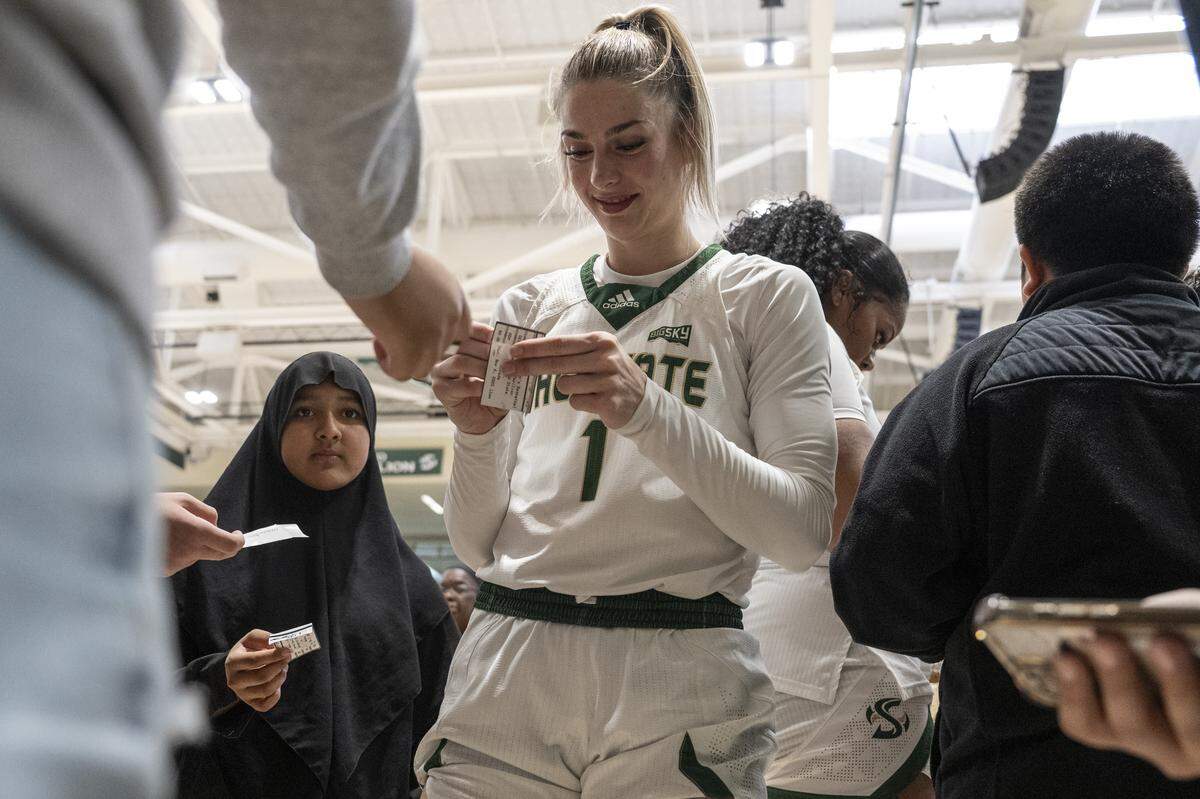 Sacramento State guard Benthe Versteeg (1) signs autographs for visiting school kids after a game against Nevada at Hornet Pavilion in Sacramento on Thursday, Nov. 6.