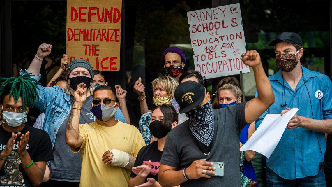 Demonstrators stand outside of the offices of the Sacramento County Board of Supervisors to call for defunding of the police in downtown Sacramento on Monday, June 15, 2020.