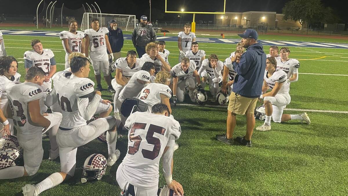 First-year Union Mine High School football coach Brandon Pacheco speaks to his team following a 28-14 victory over Rosemont on Friday, Oct. 13, 2023.