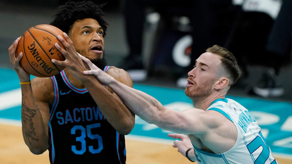 Sacramento Kings forward Marvin Bagley III, left, is fouled by Charlotte Hornets forward Gordon Hayward during the first half of an NBA basketball game on Monday, March 15, 2021, in Charlotte, N.C. (AP Photo/Chris Carlson)