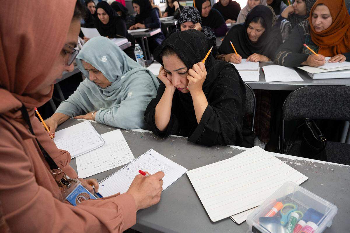 Afghan student Diba Bakhshi Kargar, 28, waits for paraeducator Nelofar Nasir, left, to check her spelling and grammar during an ESL class at Highlands Community Charter’s Edison Avenue campus in Arden Arcade last month. Bakhshi Kargar escaped on one of the last planes out of Kabul with her baby and her husband — a Special Immigrant Visa holder — when the Taliban took over Afghanistan.