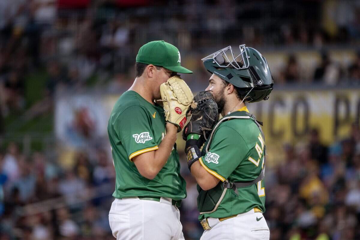 Athletics pitcher Jacob Lopez, left, talks with catcher Shea Langeliers in the fifth inning during a game against the Arizona Diamondbacks at Sutter Health Park on Friday, Aug. 1, 2025, in West Sacramento.