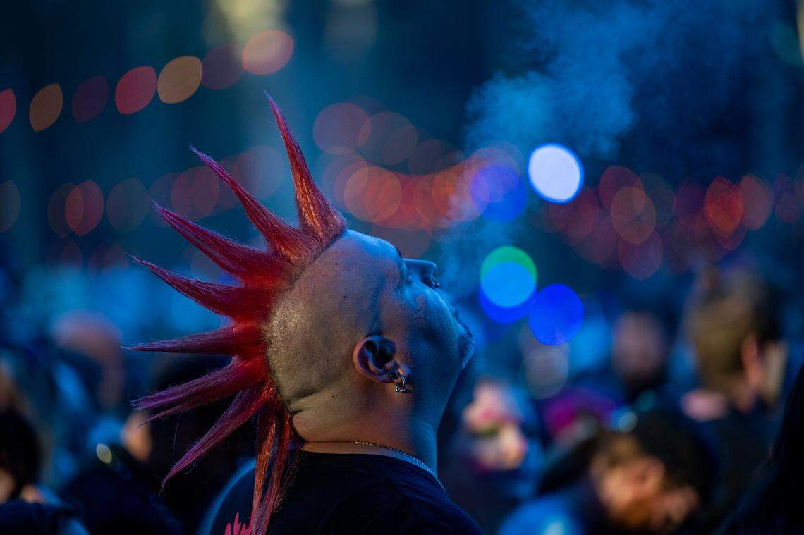 A festival attendee enjoys a smoke as he waits for Insane Clown Posse to take the stage in the first day of the Aftershock festival on Thursday, Oct. 10, 2024 at Discovery Park.