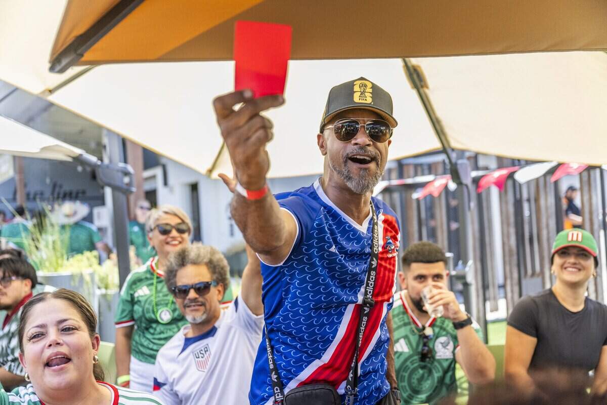 Rusty Clark pulls a red card during a watch party at Garden at the Line in Sacramento after Themba Zwane of South Africa received one during the opening World Cup match against Mexico on Thursday.