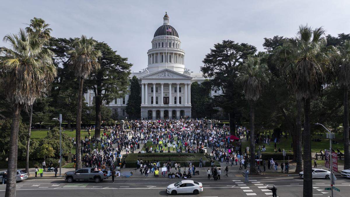 More than a thousand people rally during a student-led protest against ICE at the state Capitol on Friday.
