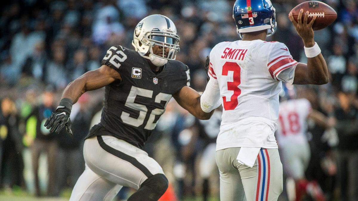 Raiders defensive end Khalil Mack, left, pressures New York Giants quarterback Geno Smith on Dec. 2, 2017, in Oakland.