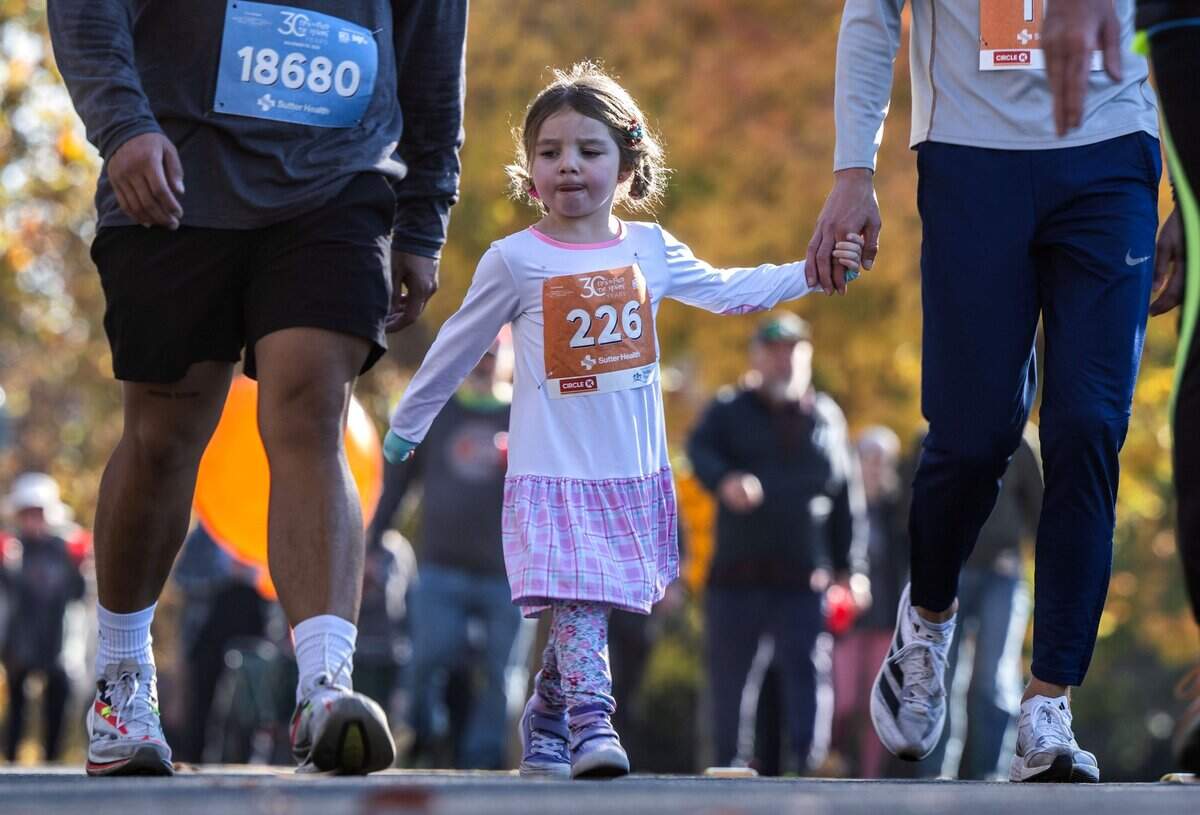 Camilla Dear walks on J Street during the 30th annual Run to Feed the Hungry on Thursday in East Sacramento.