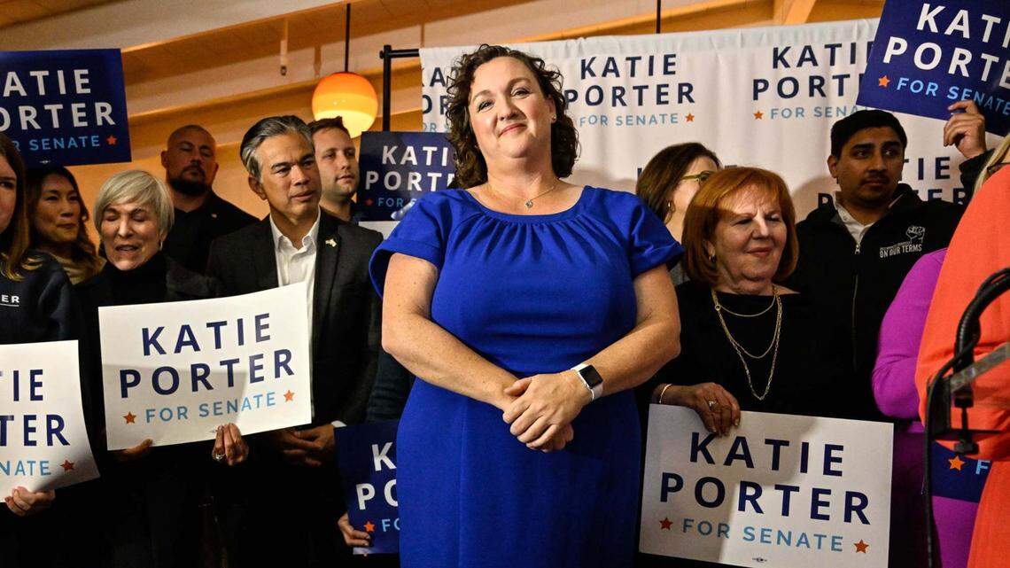 U.S. Senate candidate Katie Porter stands onstage as she listens to her daughter Betsy Hoffman, 12, introduce her on Election Night in Long Beach on Tuesday.