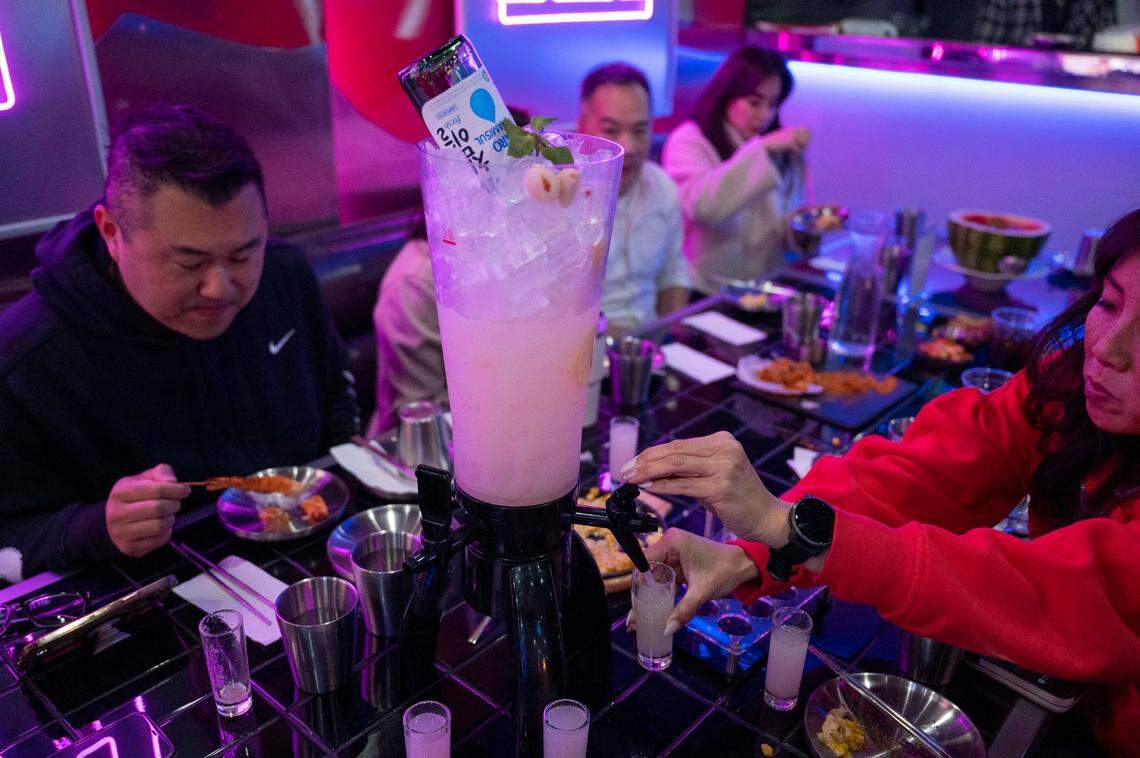 A group of friends from Connie Van Real Estate Group enjoy the lychee Soju at the newly opened Z Town Asian Gastro Bar in Elk Grove.