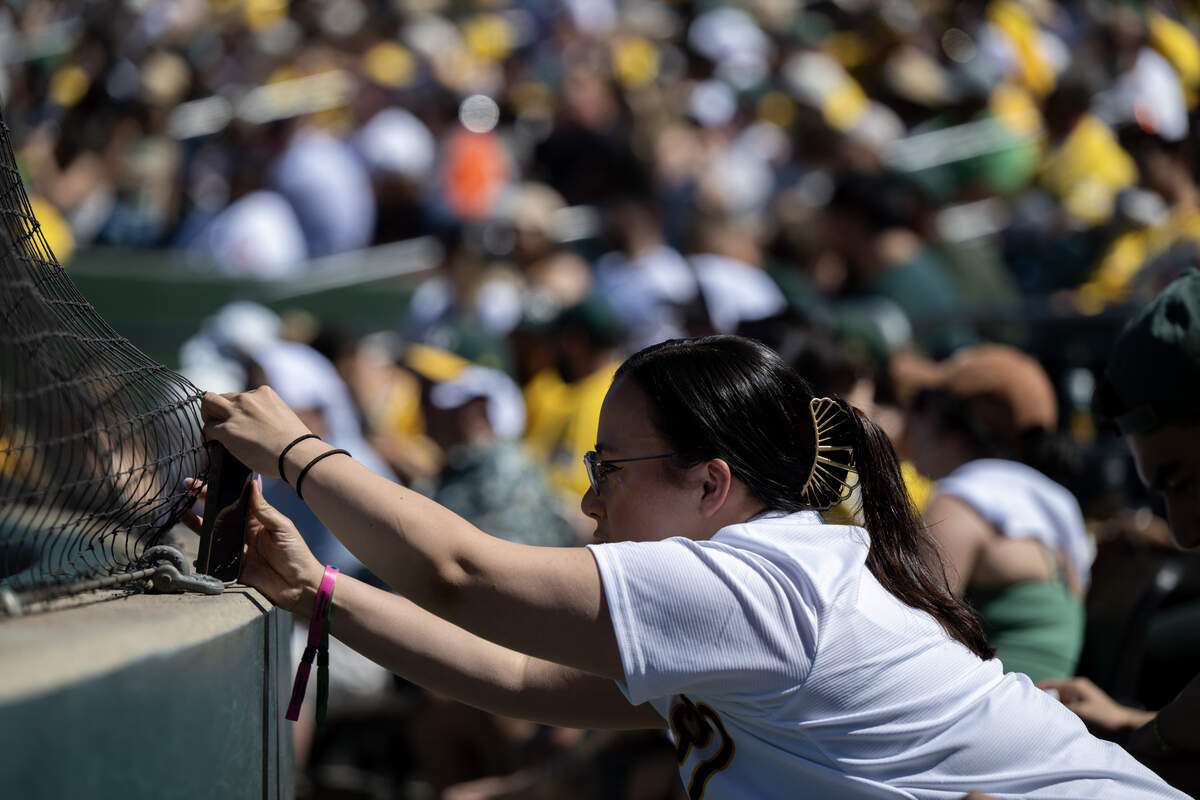An Athletics fan takes a photograph during the Athletics and Houston Astros baseball game on Saturday, April 4 at Sutter Health Park in West Sacramento.