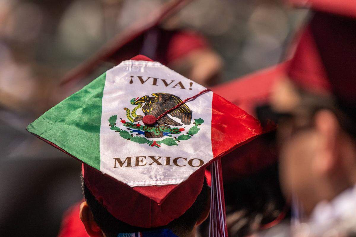 A graduating C.K. McClatchy student wears a Mexican flag on a mortarboard during the commencement ceremony on Tuesday.