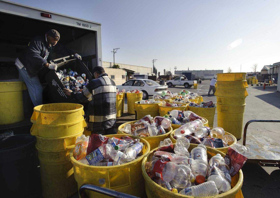 Workers unload cans and bottles at Ming’s Recycling in south Sacramento in 2012. The company shuttered its 47th Avenue bottle and can buyback site, saying aggressive state regulations and enforcement led to long lines and angry customers.