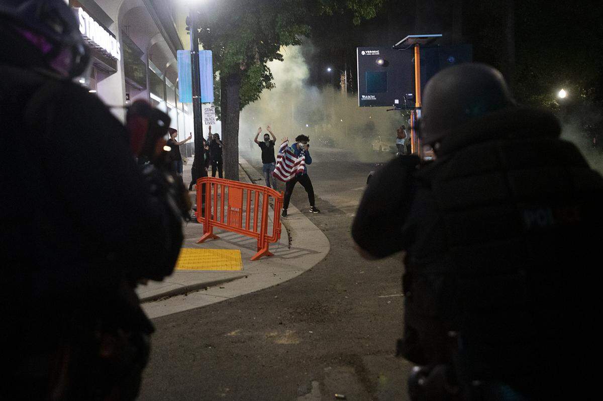 Sacramento Police fire tear gas to disperse demonstrators at 10th and L streets in Sacramento on Sunday during a protest over the death of George Floyd, who died in Minneapolis on May 25 after being detained by police.