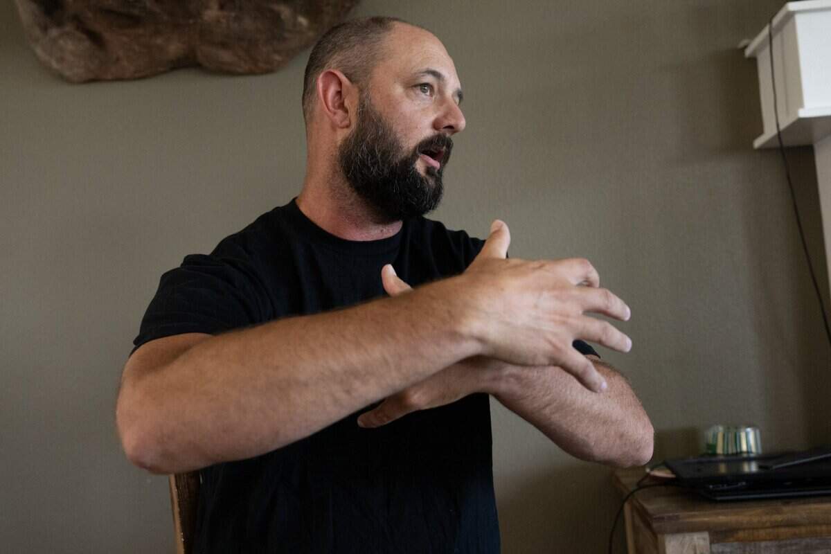 Joel French demonstrates how Bradley Earl Reger would attempt to hug him in the 1990s, when he was a young teenager, during activities at Cornerstone Christian School, where Reger volunteered as a bible class teacher and chaperoned mission trips.