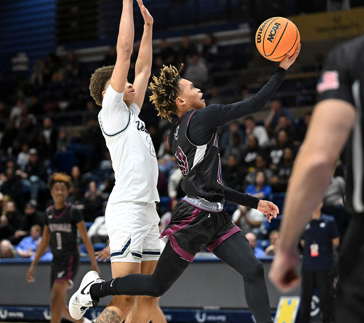 Natomas’ Dereon Jenkins drives past Venture Academy defender Mario Williams during the Sac-Joaquin Section Division IV championship game at UC Davis on Friday.