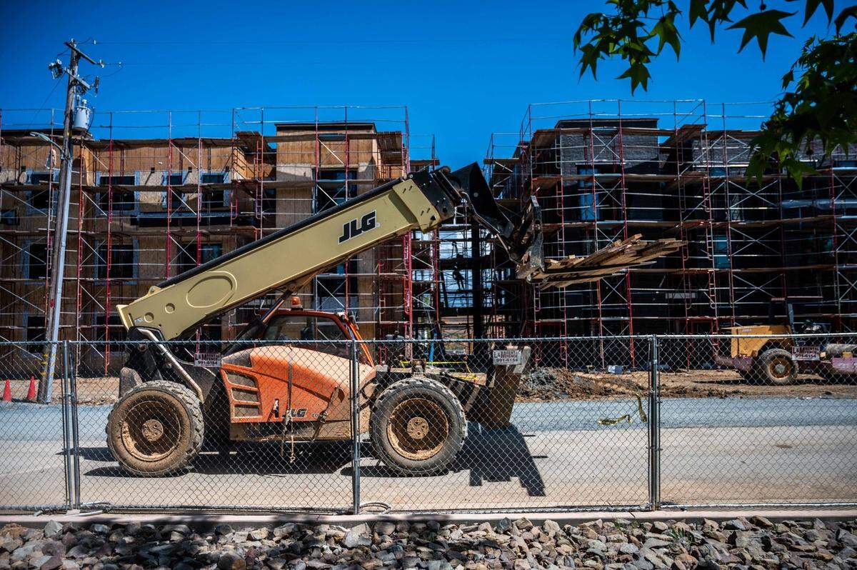 A construction vehicle passes by the Mercy affordable housing development in Auburn on Wednesday, April 14, 2021. The project contains 79 units.