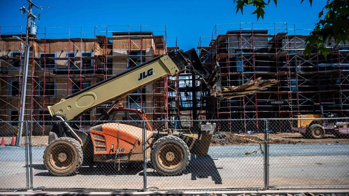 A construction vehicle passes by the Mercy affordable housing development in Auburn on Wednesday, April 14, 2021. The project contains 79 units.