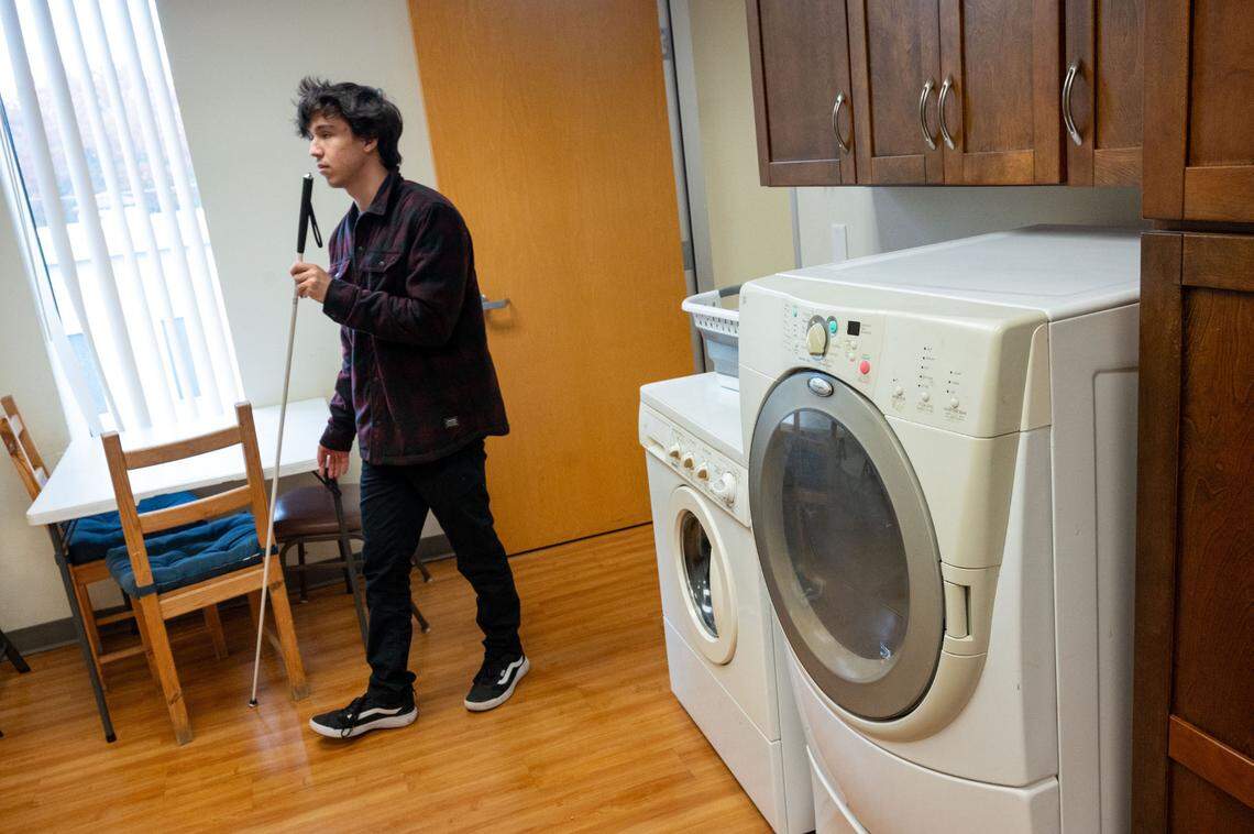 Spencer Parod walks through the instructional kitchen and living skills area at Society for the Blind on Nov. 25. A gift from the Book of Dreams would help them buy a new washer and dryer and upgrade some kitchen appliances.