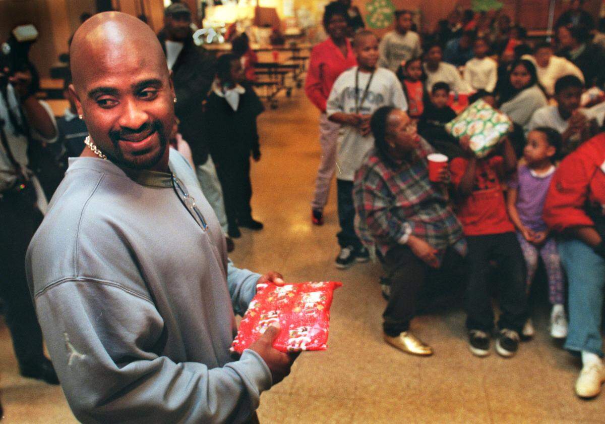 Major league baseball star Greg Vaughn gives presents to kids at John Sloat Elementary School in Sacramento in 1999. Vaughn, who had just signed a $35 million deal with Tampa Bay, attended the school while growing up in Meadowview.