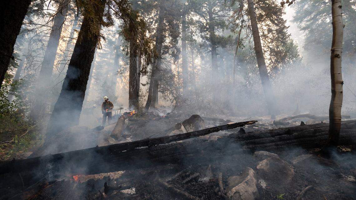 El Dorado county firefighters protect homes on Snowflake Drive in Christmas Valley on Tuesday, Aug. 31, 2021, as the Caldor Fire burned into the South Lake Tahoe Basin, down from Echo Summit.