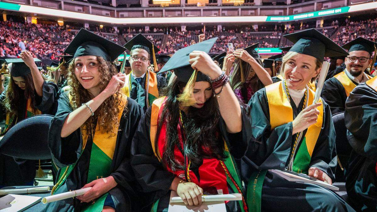 Graduates Madison Coronado, left, Danielle Rubalcava, and Natalie Marraccini move their tassels after walking the stage to receive their diplomas Friday May 20, 2022, at Golden 1 Center.
