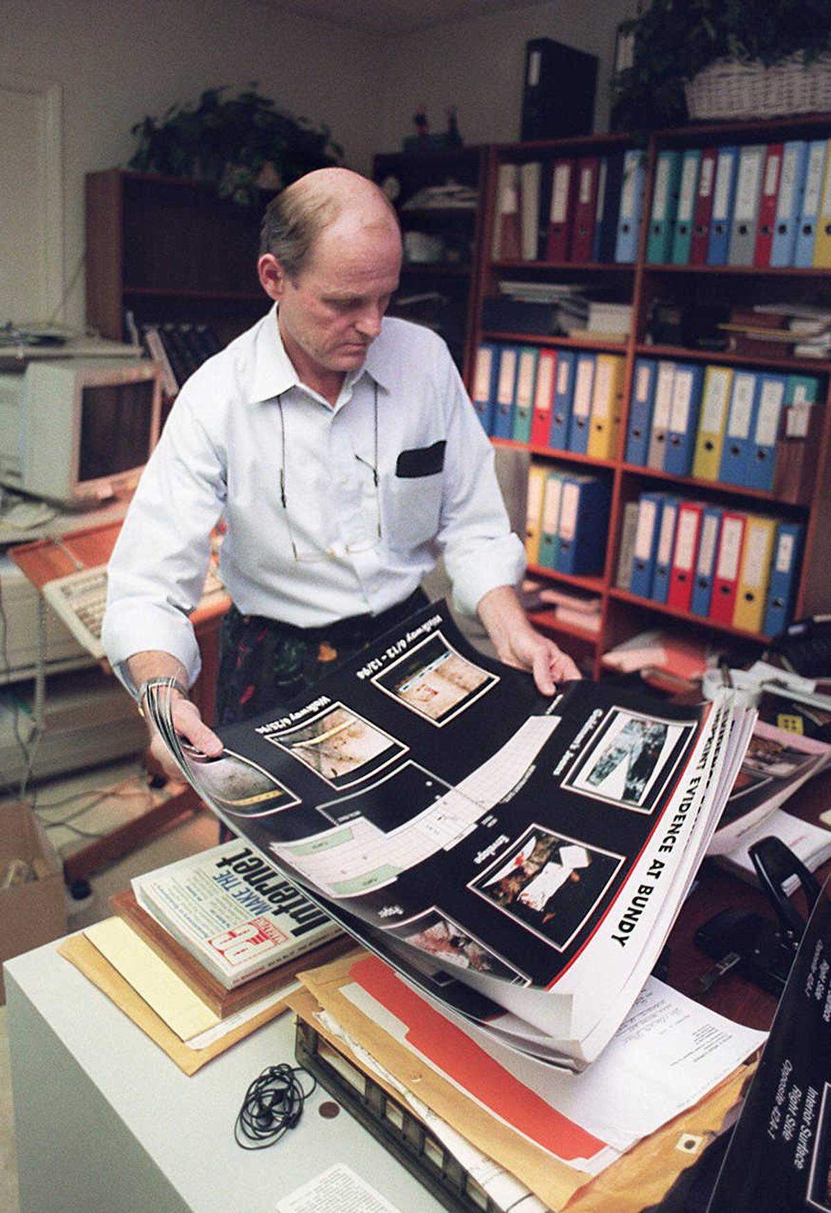 Attorney Robert Blasier looks over evidence photographs in his Sacramento home office on Oct. 4, 1995, the day after the not guilty verdict in the O.J. Simpson trial.