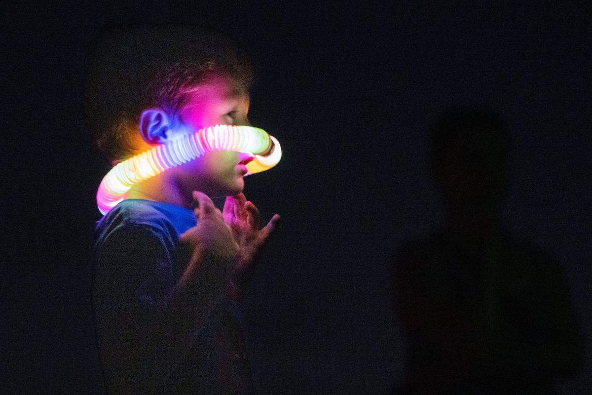 Liam Keen, 4, jumps around while waiting for the California Capital Airshow’s closing performance at Mather Airport near Rancho Cordova on Saturday, July 13, 2024. Keen and several other children played a game of duck, duck, goose to pass the time.