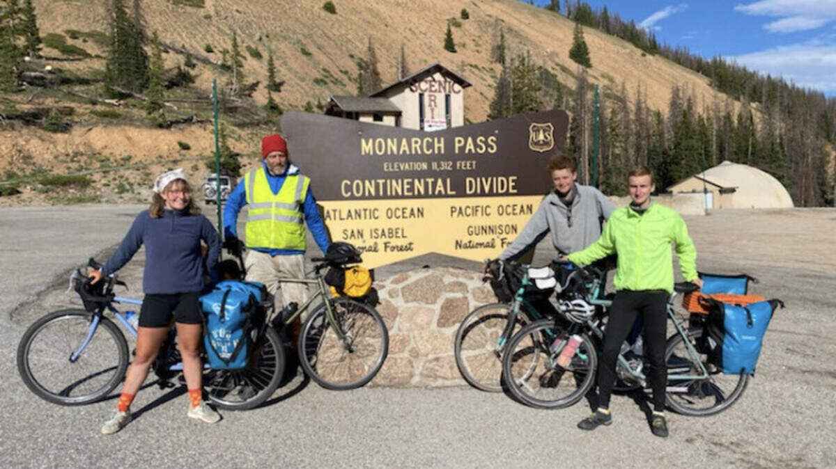 “Pedal Towards the Future” cyclists catch their breath and celebrate cresting the Rocky Mountains.