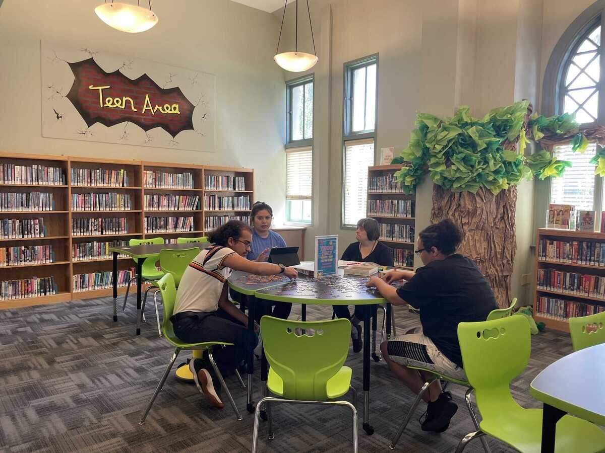 Patrick Schrodeder, Gina Brusco, Heidy Zapien and Emani Frye work on putting together a puzzle in the Teen Area at the Woodland Public Library on July 24, 2023.