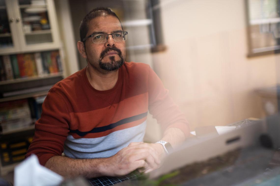 Marco Martinez works in a shared home office Tuesday, May 12, 2020, in Sacramento. Martinez, a Sacramento State employee, has been primarily working from home while wife, UC Davis School of Veterinary Medicine faculty member Betsy Vaughan, has been doing a combination of working at home and in person.