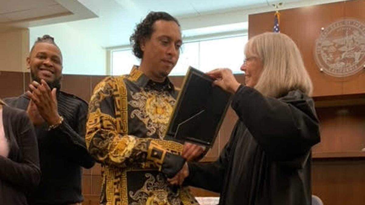 Joseph Rodriguez celebrates completing his diversion program with Judge Janet Gaard in Yolo County court on Wednesday, March 15, 2023. Rodriguez was one of the first two graduates for the program, which treats adult offenders in the cracks of rehabilitation