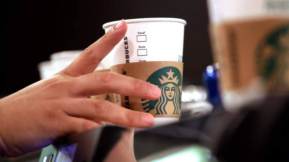 In this May 29, 2018, file photo, a barista reaches for an empty cup at a Starbucks.