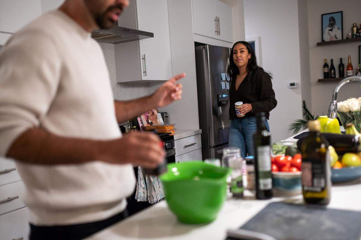 Abram Diaz, left, works with fiancé Riana King to prepare dinner in the modern kitchen of their home at The Mill in January.