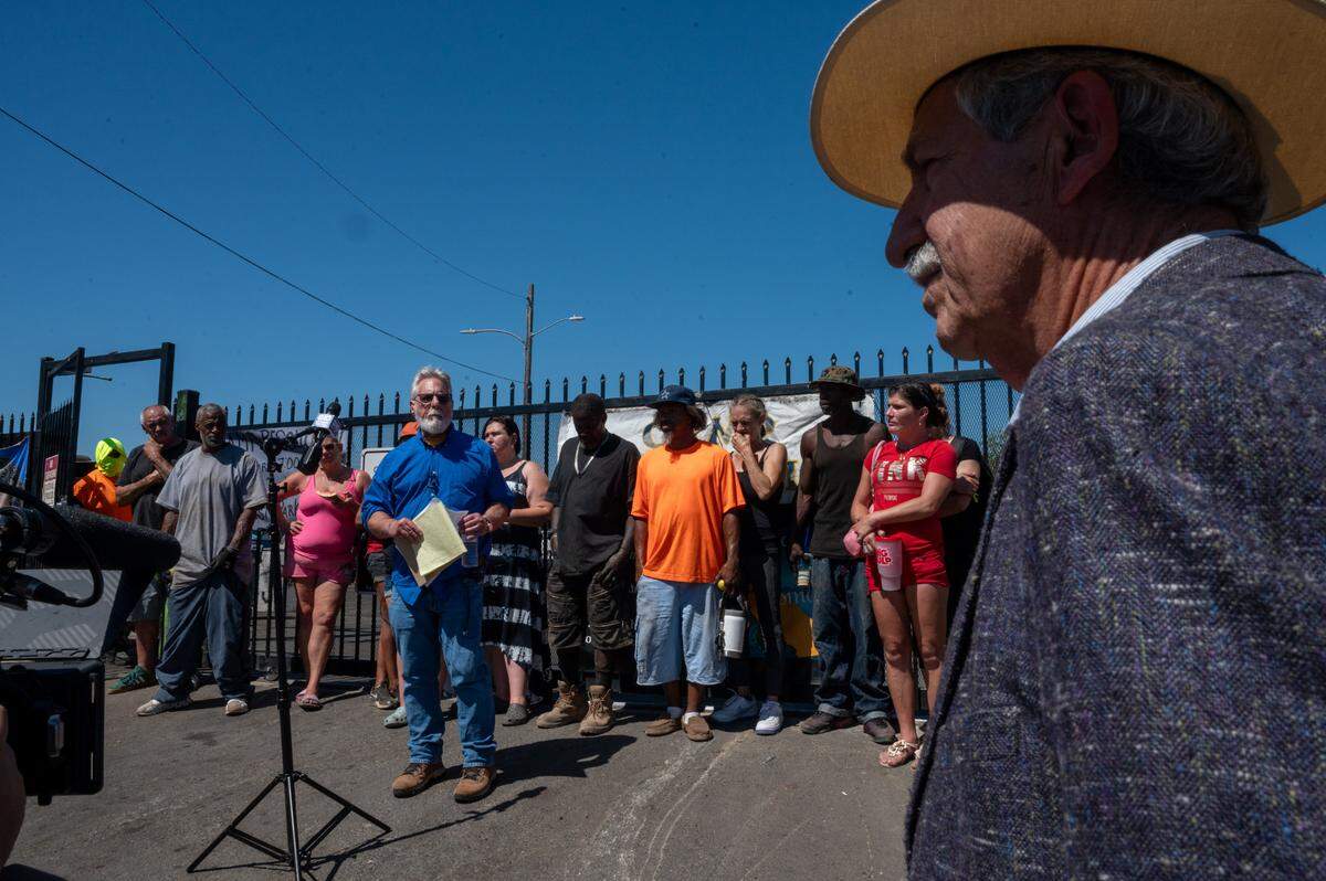 Safe Ground Sacramento attorney Mark Merin, right, attends a press conference at Camp Resolution in North Sacramento on July 18, where California Homeless Union attorney Anthony Prince, left, called on him to stop a planned city inspection of the site. The inspection did not occur.