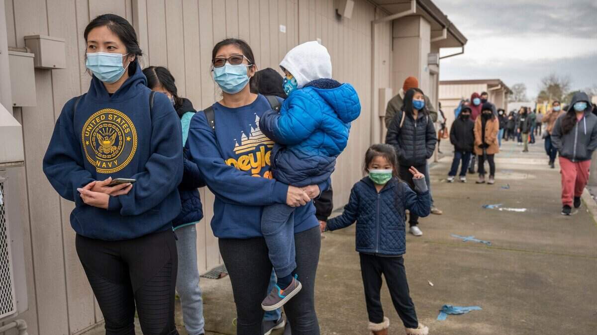 Heile Gantan, a UC Irvine student braved the cold morning on Monday, Jan. 3, 2022 to get a COVID-19 test at the La Familia Counseling Center in south Sacramento with her sister Theresa Gantan-Soliven, holding son Rowen Soliven, 3, as daughter Melody Soliven, 5, stands nearby. Gantan-Soliven said her daughter Melody tested positive for COVID-19 in a rapid test and they wanted to make sure no one else in their family had it.