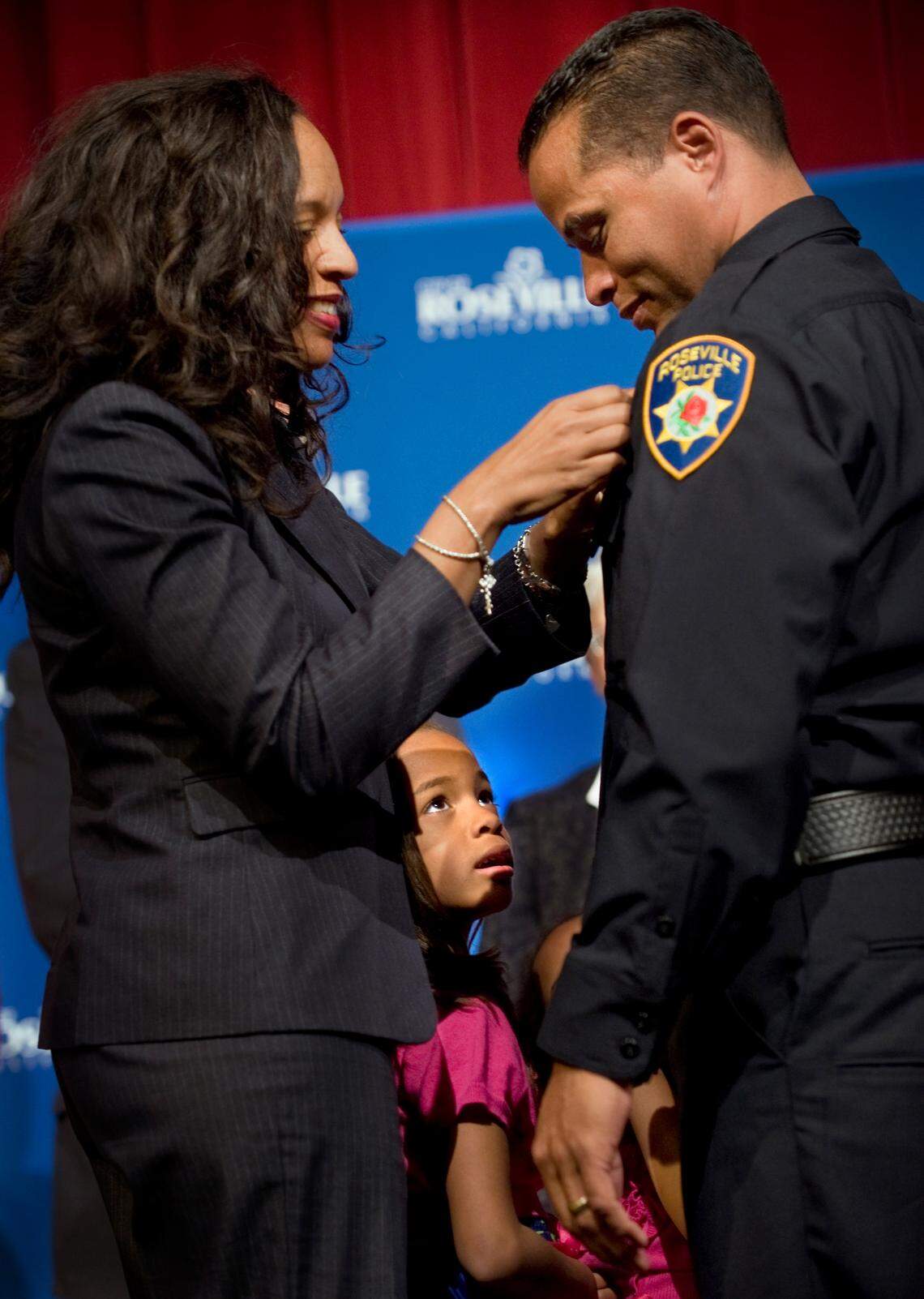 Katrina Hahn pins the badge on husband Daniel Hahn when he became Roseville’s police chief in 2011. Hahn was the first Black leader of both the Roseville and Sacramento police departments.