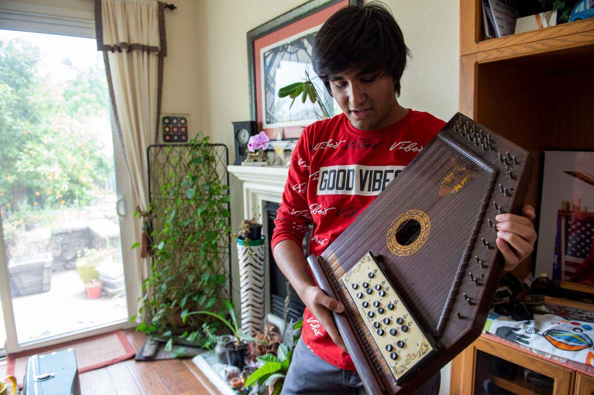 Neil Nayyar shows an American mandolin harp from the 1930s at his home in Elk Grove.