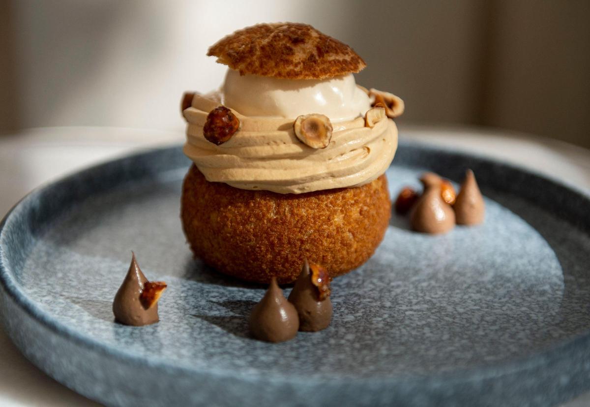 A cream puff with hazelnut praline ice cream, caramel chantilly and chocolate is served at the Hyatt Centric’s new restaurant, The 7th Street Standard.