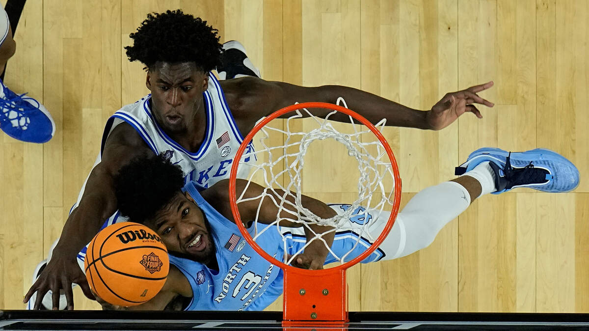 North Carolina guard Dontrez Styles (3) shoots against Duke forward AJ Griffin during the first half of a college basketball game in the semifinal round of the Men’s Final Four NCAA tournament, Saturday, April 2, 2022, in New Orleans. (AP Photo/Brynn Anderson)